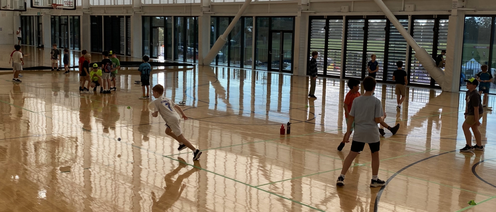 Kids having fun playing handball at a holiday camp program
