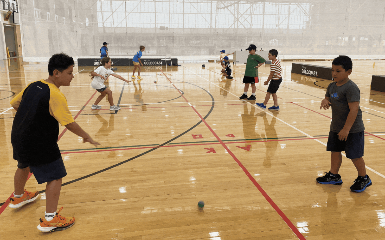 Kids having fun playing handball at a holiday camp program