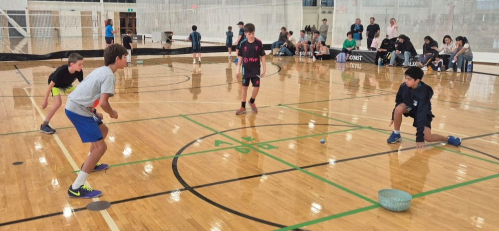 Kids having fun playing handball at a holiday camp program