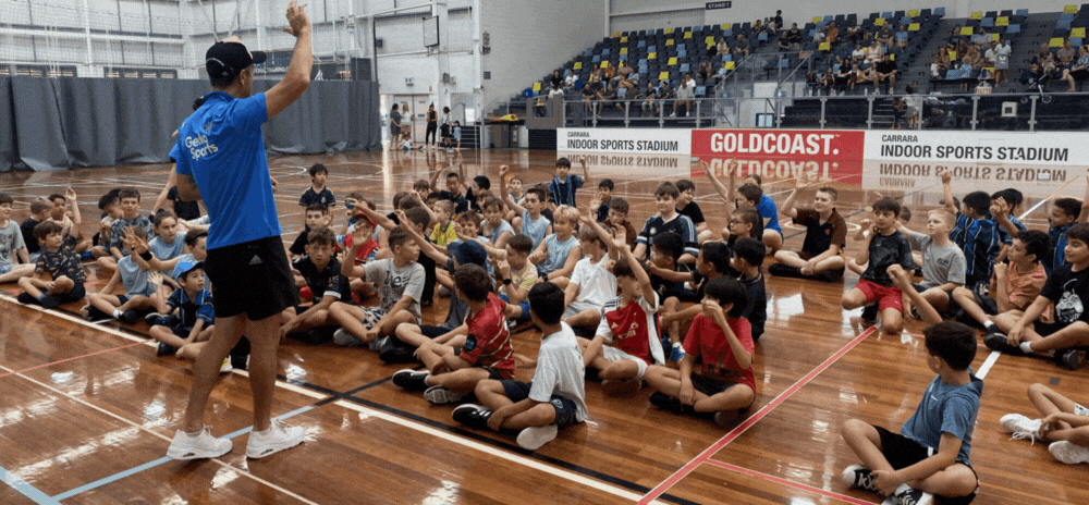 Kids having fun playing handball at a holiday camp program