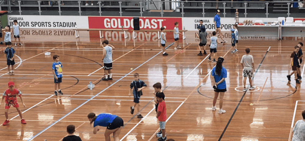 Kids having fun playing handball at a holiday camp program