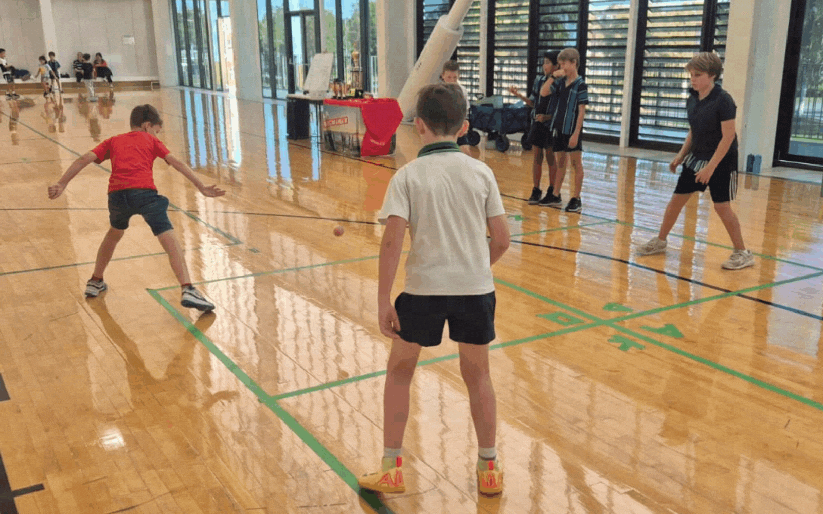 Kids having fun playing handball at a holiday camp program