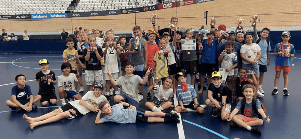 Kids having fun playing handball at a holiday camp program