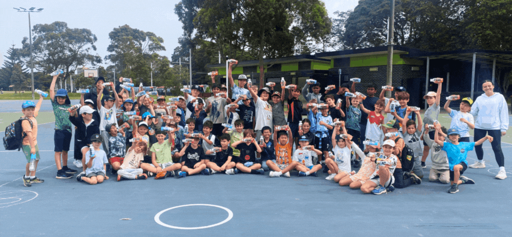 Kids having fun playing handball at a holiday camp program